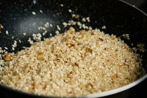 Process of cooking risotto in frying pan photo