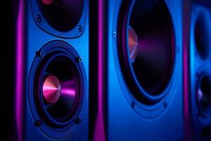 Two sound speakers and subwoofer on dark background with neon lights photo