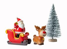 Christmas tree and Santa Claus in sleigh with reindeer isolated on white or transparent background. photo