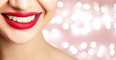 Woman smile closeup against an abstract background with blurred lights photo