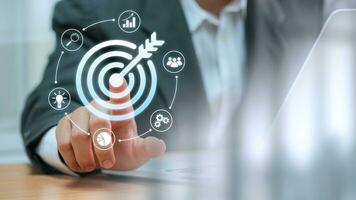 Businessman touching target board for creative and set up business objective target and success. business plans goals and business strategy and competitive advantage banking and finance success goals photo