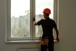 Workman repairing a large picture window photo