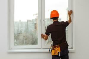 Workman repairing a large picture window photo