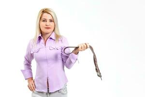 Angry young mother with belt on her hands photo