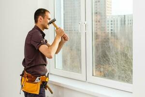 Workman repairing a large picture window photo