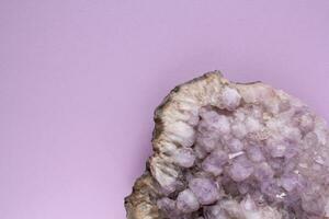 Natural amethyst druse geode mineral crystal unpolished semi-precious gemstone. Magic rock for ritual, witchcraft, spiritual practice, meditation. Esoteric life balance concept. Copy space photo