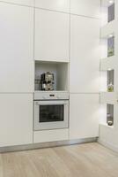 Modern white kitchen without handles photo