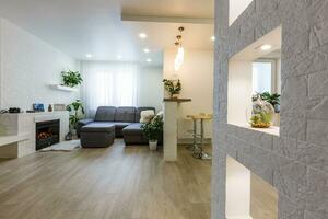 living room with big window and brown wall interior photo