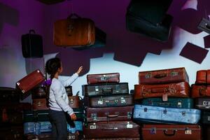 The little girl with old retro suitcases. photo