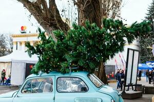 Kiev, UKRAINE - January 26, 2020 Winter Country vdnh exhibition decorated for new year and christmas holidays, old car with a tree photo