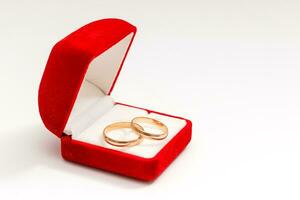 wedding rings in a gift box on white background photo