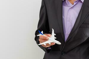 View on man which holding plane in hand. Fly, flight concept. Isolated on white color. photo