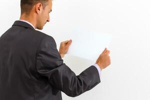 businessman holding a blank white board, signboard, showing an emty bill board against white background photo