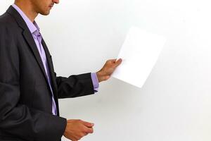 businessman holding a blank white board, signboard, showing an emty bill board against white background photo