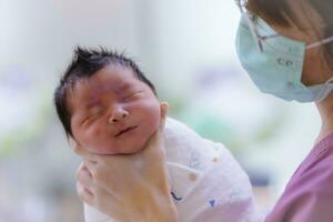 The Baby boy was just born with Baby cloth wrapped around the whole body photo