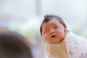 The Baby boy was just born with Baby cloth wrapped around the whole body photo