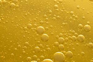 Oil bubble texture on gold background. photo