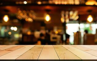 Empty wooden table top with lights bokeh on blur restaurant background photo