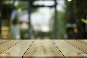 Empty wooden table top with lights bokeh on blur restaurant background. photo