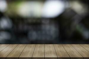 Empty wooden table top with lights bokeh on blur restaurant background. photo