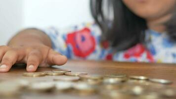 child girl counting coins on table video