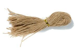 Brown twine rope on a white isolated background, top view. Packing natural photo