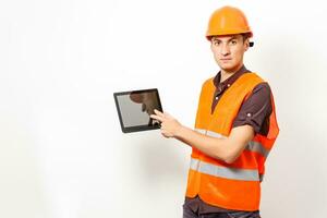 Construction specialist using a tablet computer. At a construction site. photo