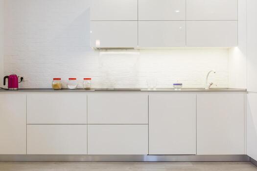 Modern white kitchen without handles photo
