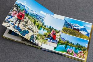 the photobook opened, travel in switzerland, on gray background photo