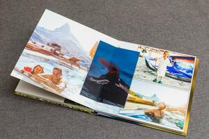 the photobook opened, travel in switzerland, on gray background photo