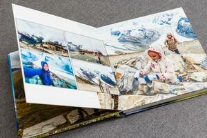 the photobook opened, travel in switzerland, on gray background photo