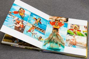 Photobook album on deck table with travel photos