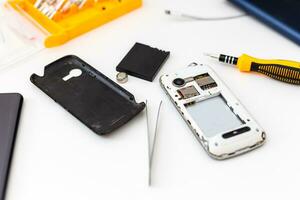 Disassembled smartphone, mobile phone repairing, flat lay, top view photo