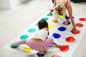 kid girl and mother playing together at home photo