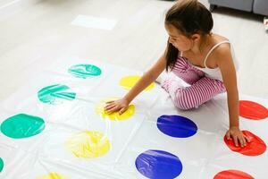 little girl plays in the kids room photo