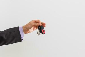 businessman holding a car key photo