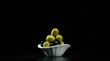 Olives fruit green and black gyrating on black background video