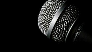 Radio microphone gyrating at black background video