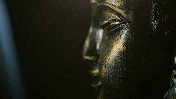 Buddha face, god buddhist, rotating at black background justify at right video