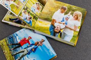 Photobook album on deck table with travel photos