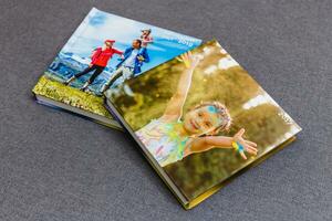 Photobook album on deck table with travel photos