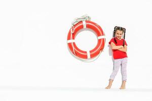 Portrait of little girl sea theme, little girl and lifebuoy photo