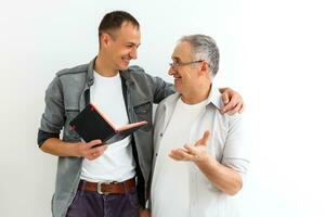 Senior father with adult son talking, isolated white background. photo