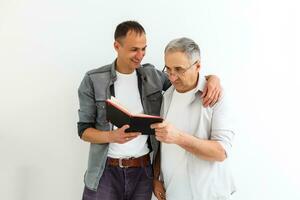 Senior father with adult son talking, isolated white background. photo