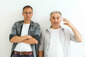 Senior father with adult son talking, isolated white background. photo