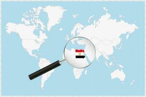 Magnifying glass showing a map of Egypt on a world map. vector