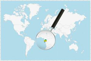 Magnifying glass showing a map of Gabon on a world map. vector