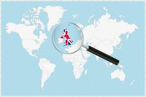 Magnifying glass showing a map of United Kingdom on a world map. vector