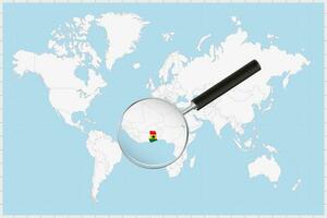 Magnifying glass showing a map of Ghana on a world map. vector
