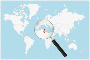 Magnifying glass showing a map of Tunisia on a world map. vector